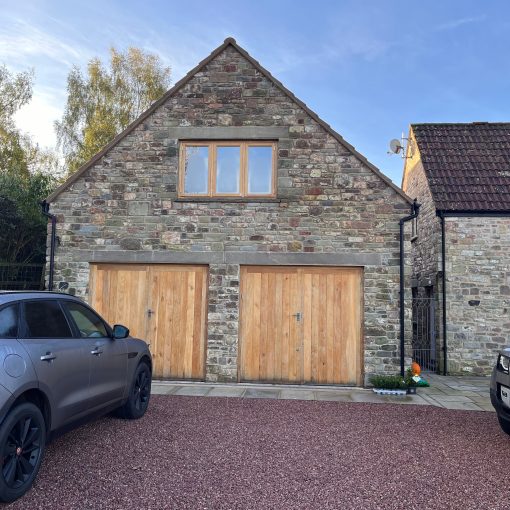 Cars outside new double garage extension designed by Apex Architecture